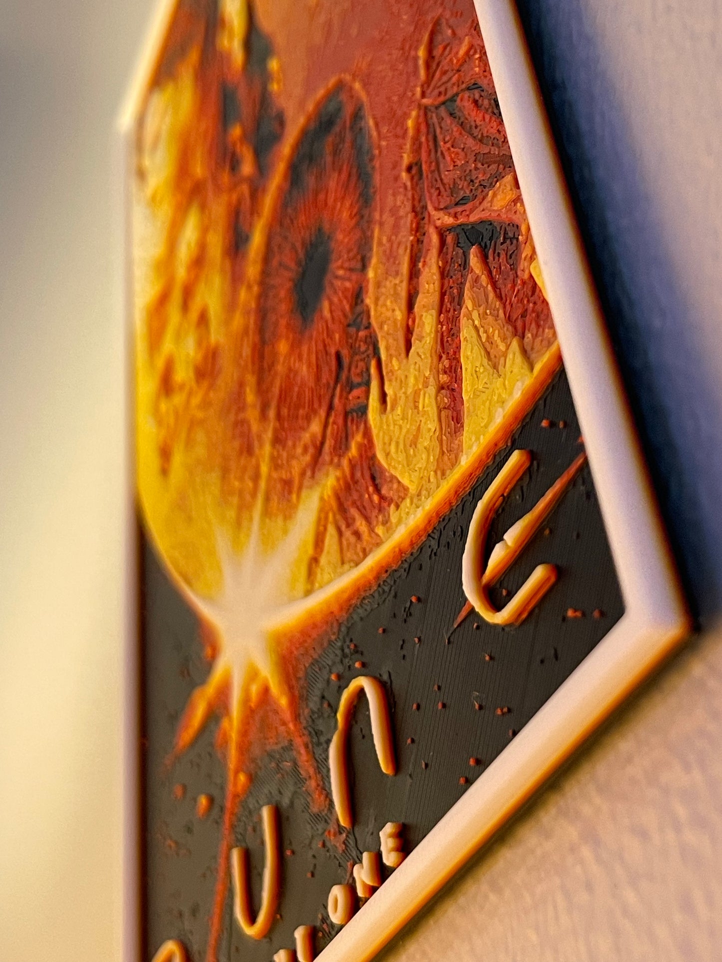 Decorative wall art with abstract design and text on a wooden surface