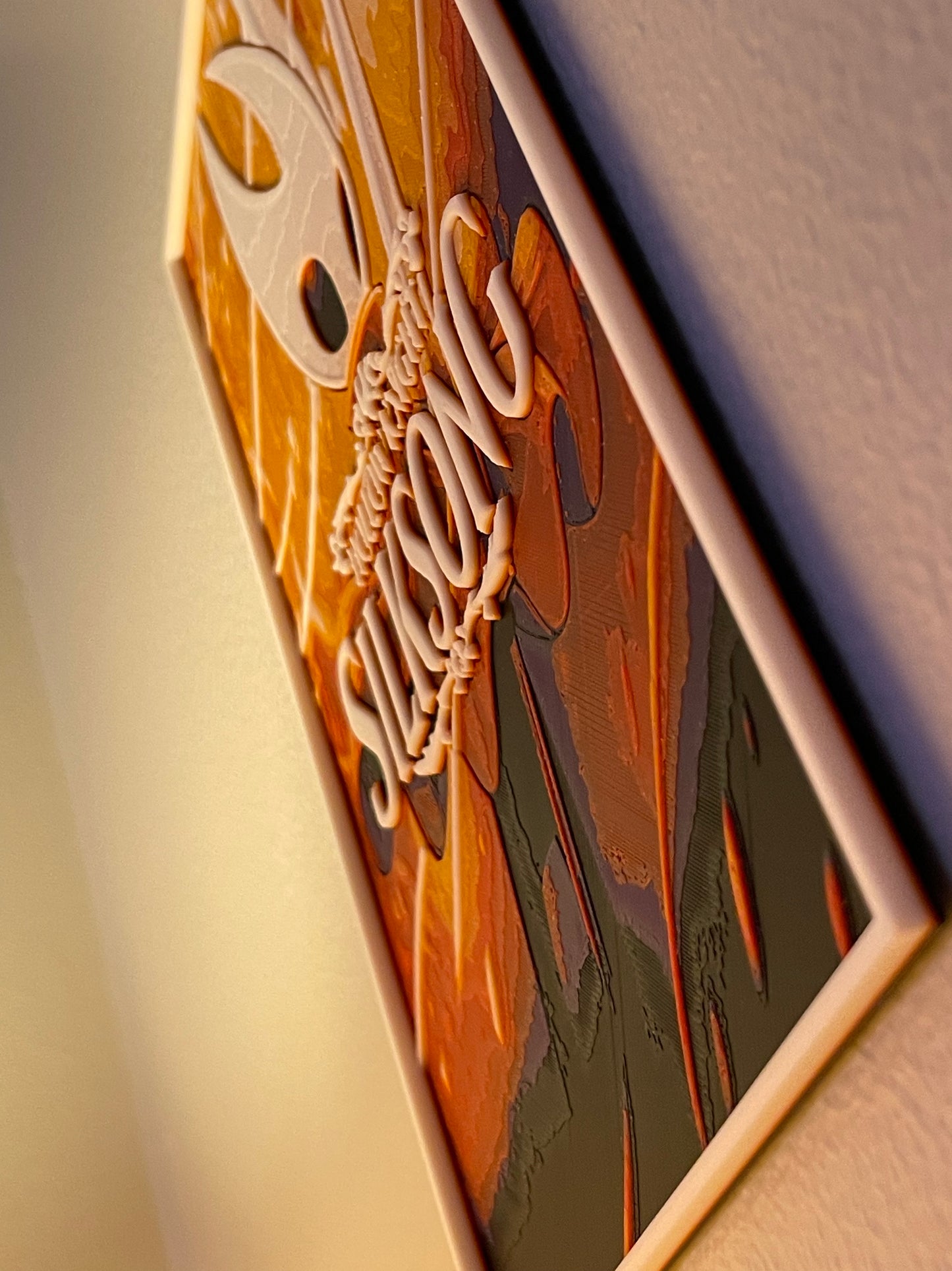 poster with 'silksong' engraved on it, placed on a textured surface.