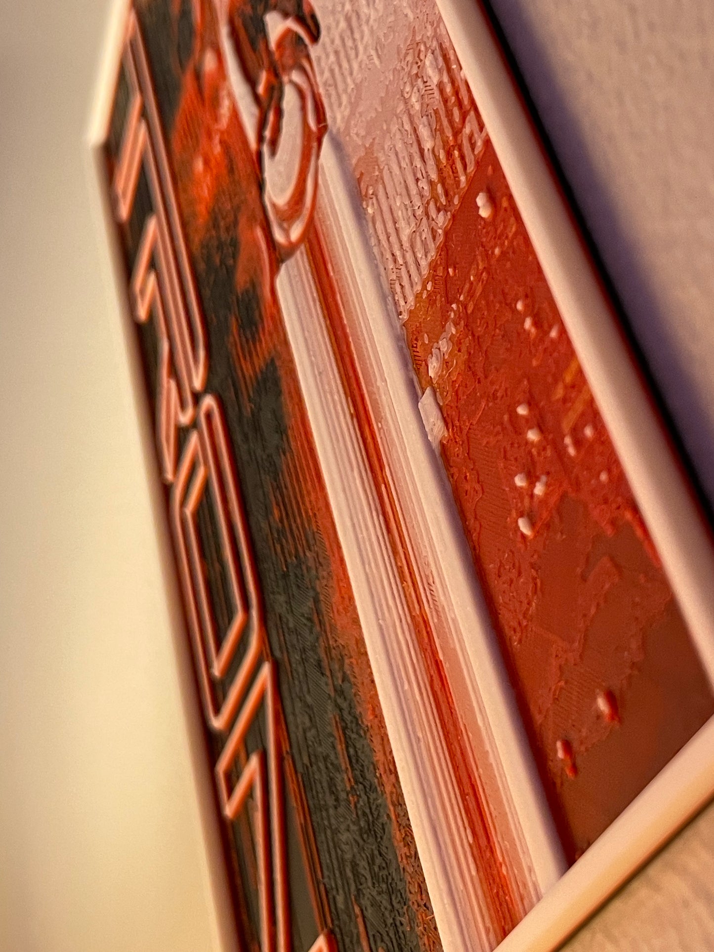 Close-up of a poster cover and text on a blurred background