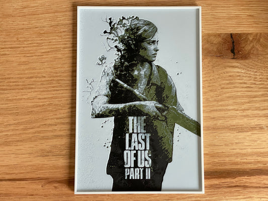 Poster of a character from 'The Last of Us Part II' on a wooden surface