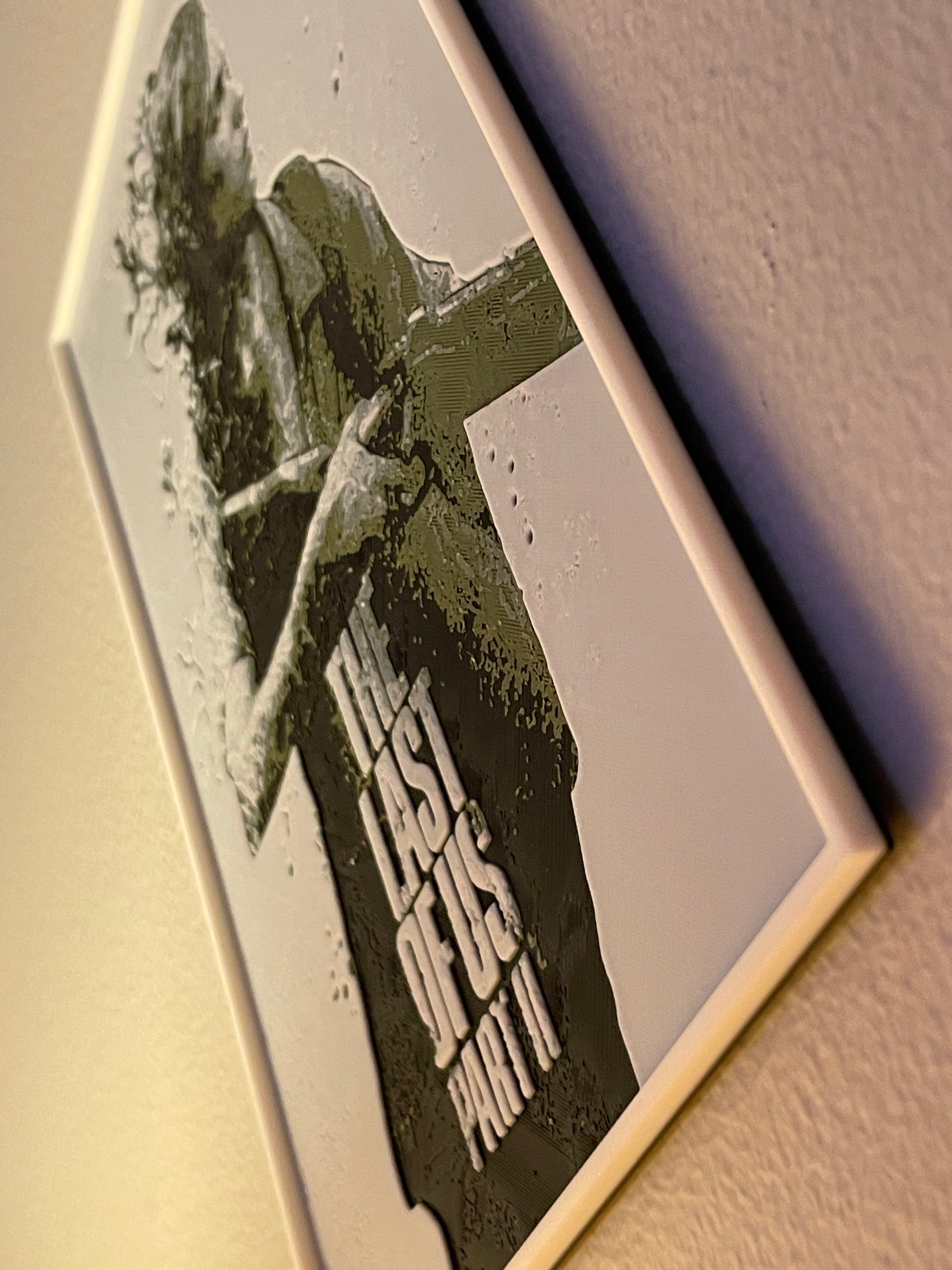 Game case for 'The Last of Us Part II' with a character holding a gun on a textured surface.