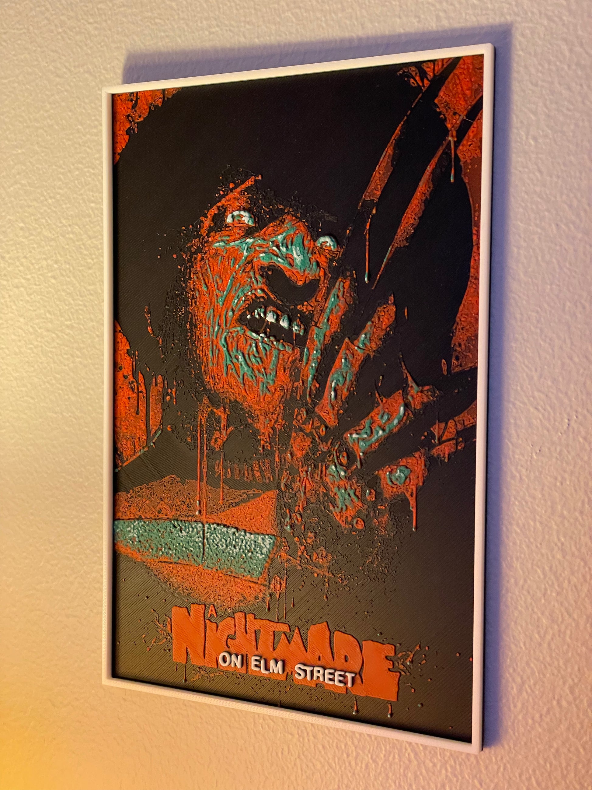 Framed poster of a character from 'Nightmare on Elm Street' on a wall.