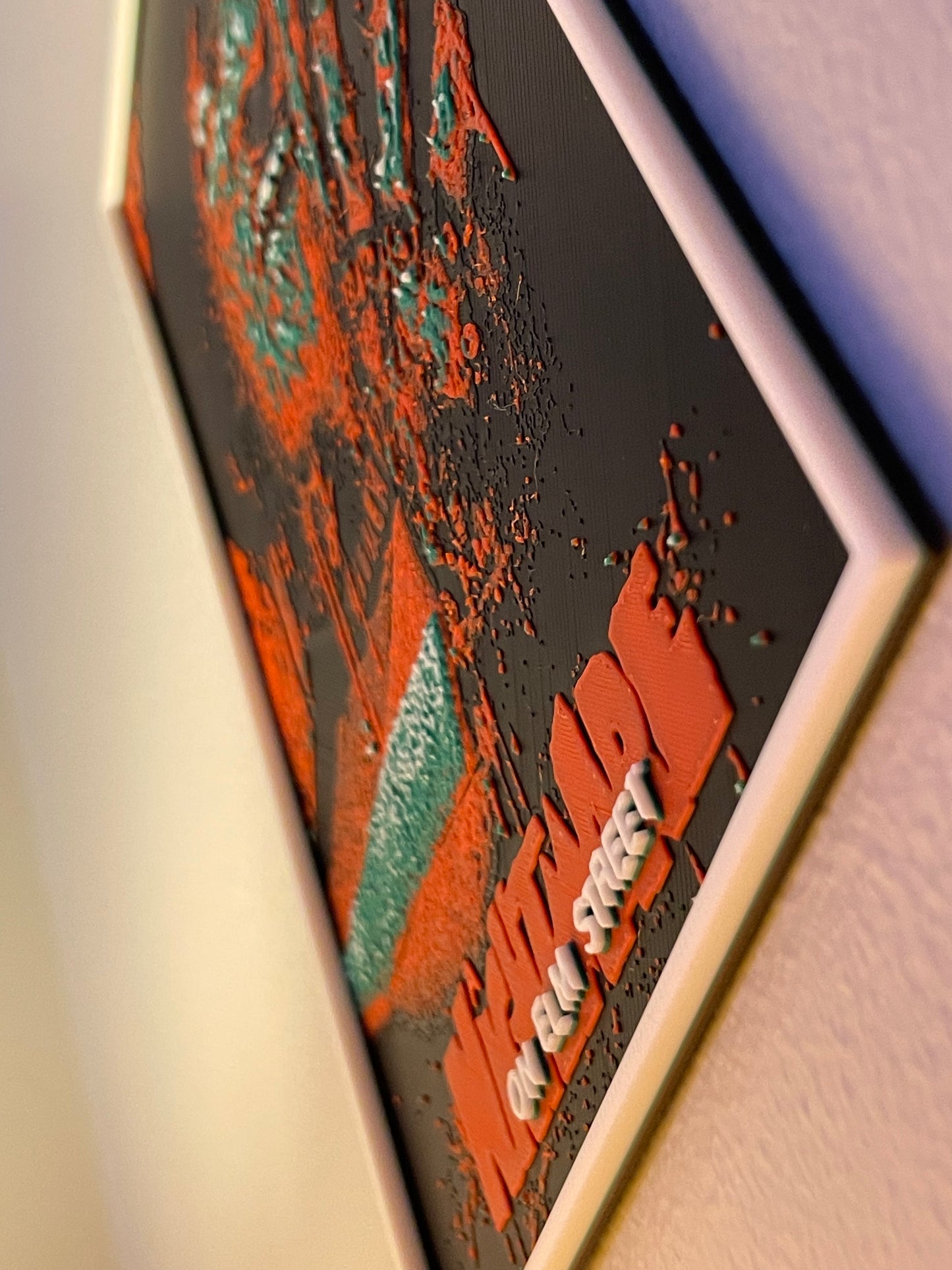 Close-up of a textured surface with red and green patterns and 'freddy' branding.