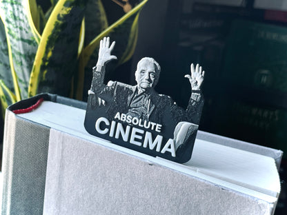 Decorative bookend with a black and white image of a person and 'Absolute Cinema' text on a shelf.