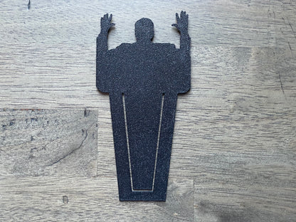 Silhouette of a person with arms raised on a textured surface