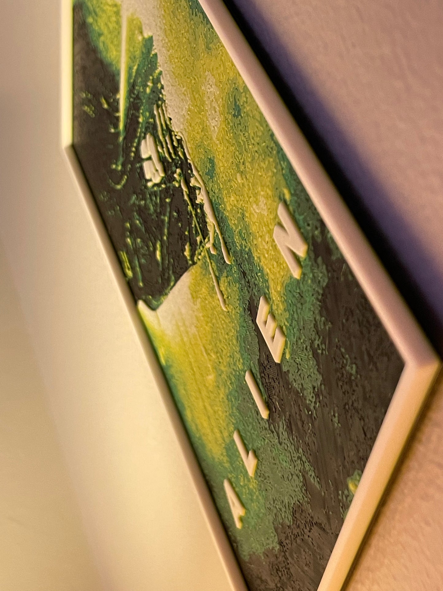 Close-up of a 'Alien' movie poster with a blurred background