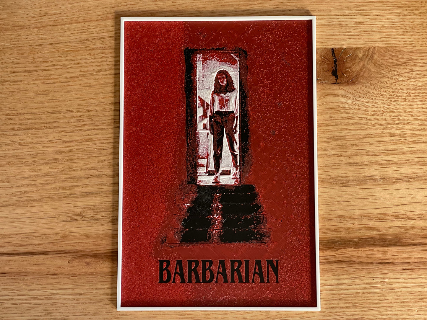 Card with a stylized illustration of a character in a doorway and the word 'Barbarian' on a wooden surface.
