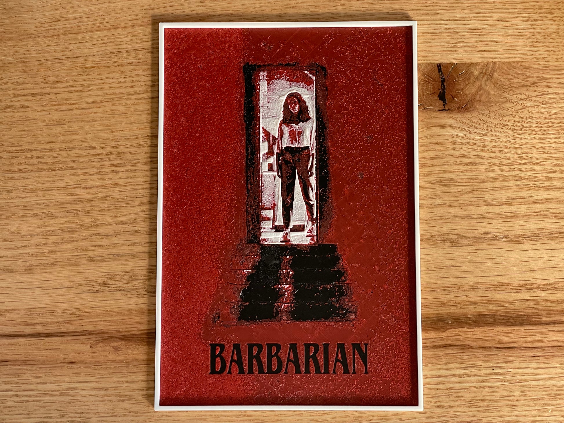 Card with a stylized illustration of a character in a doorway and the word 'Barbarian' on a wooden surface.