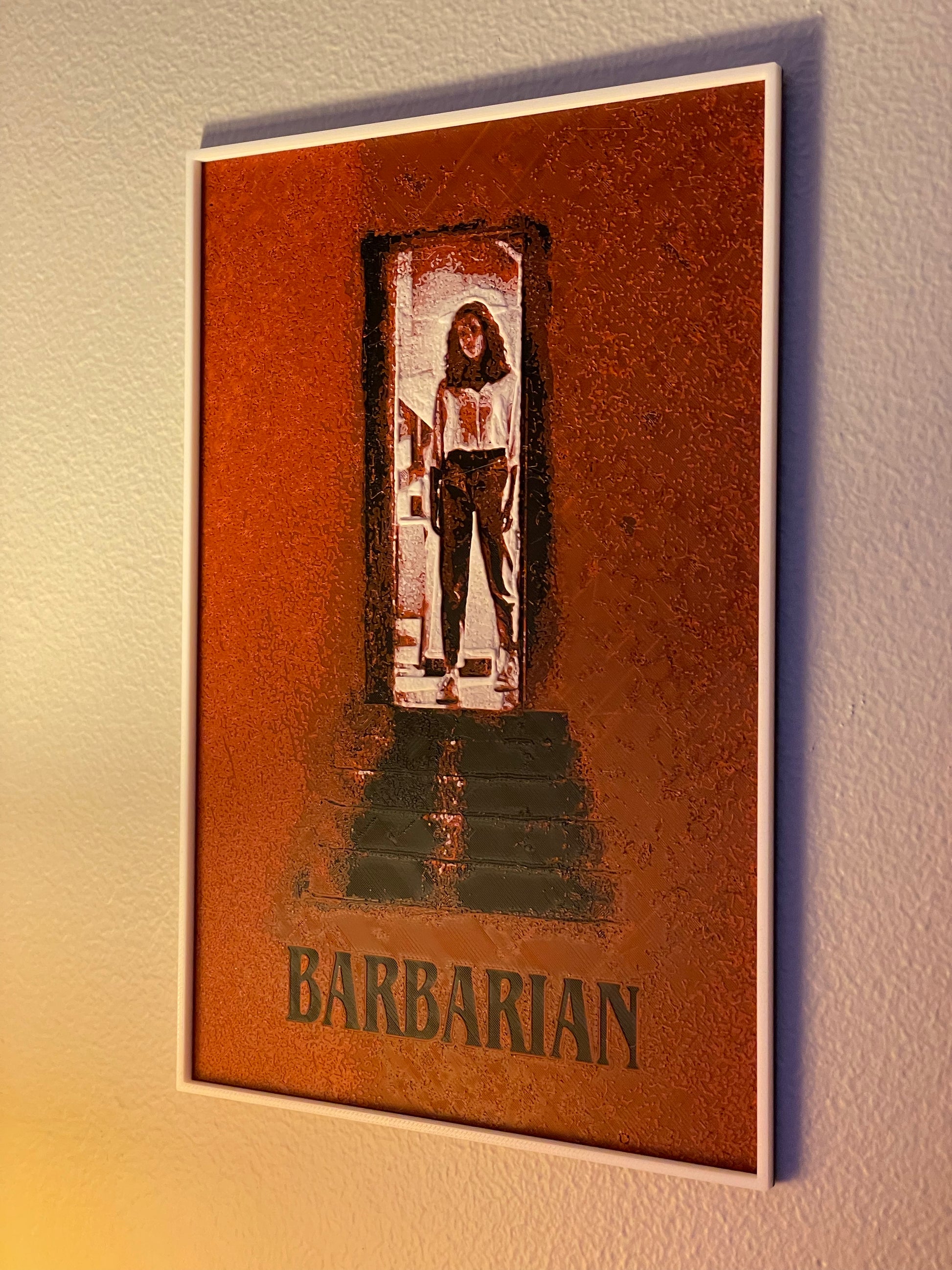 Framed poster of a character named 'Barbarian' on a textured wall.