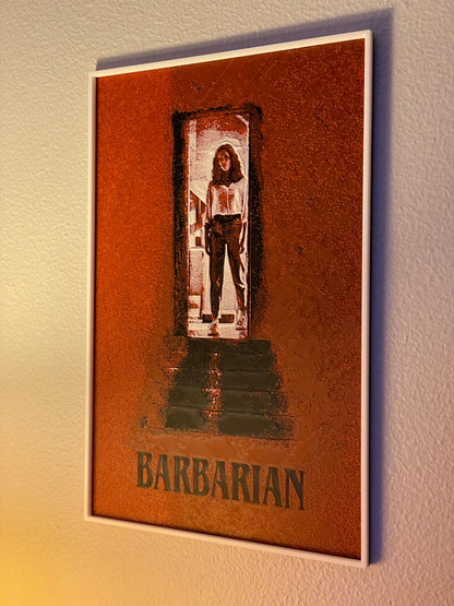 Framed poster of a character named 'Barbarian' on a textured wall.