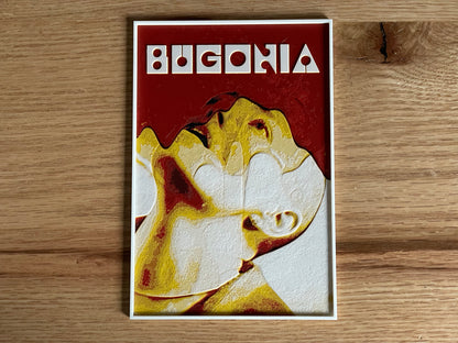 Poster with 'Buggonia' design on a wooden surface