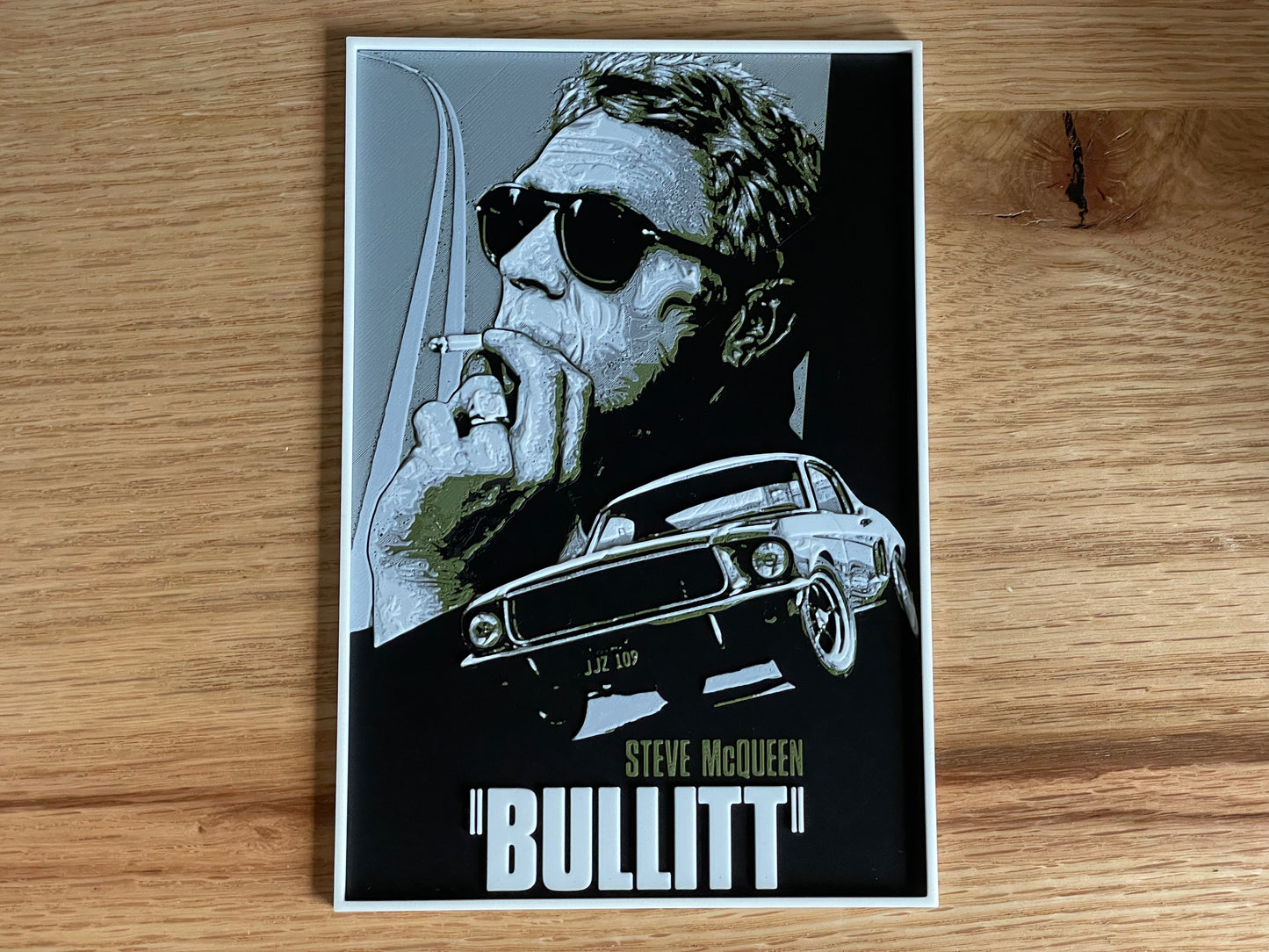 Poster of a movie with a stylized portrait and car on a wooden surface