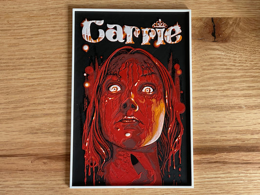 Poster of 'Carrie' with a stylized illustration on a wooden surface