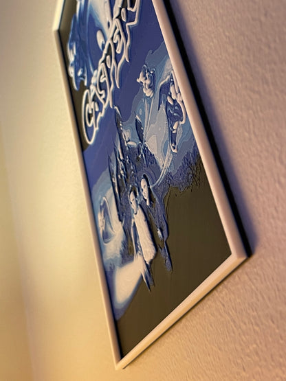 Framed artwork of a couple in a scenic setting on a textured wall.
