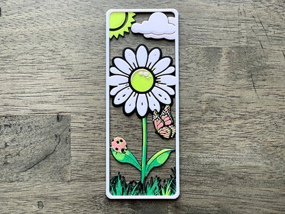 Decorative bookmark with a flower design on a wooden surface