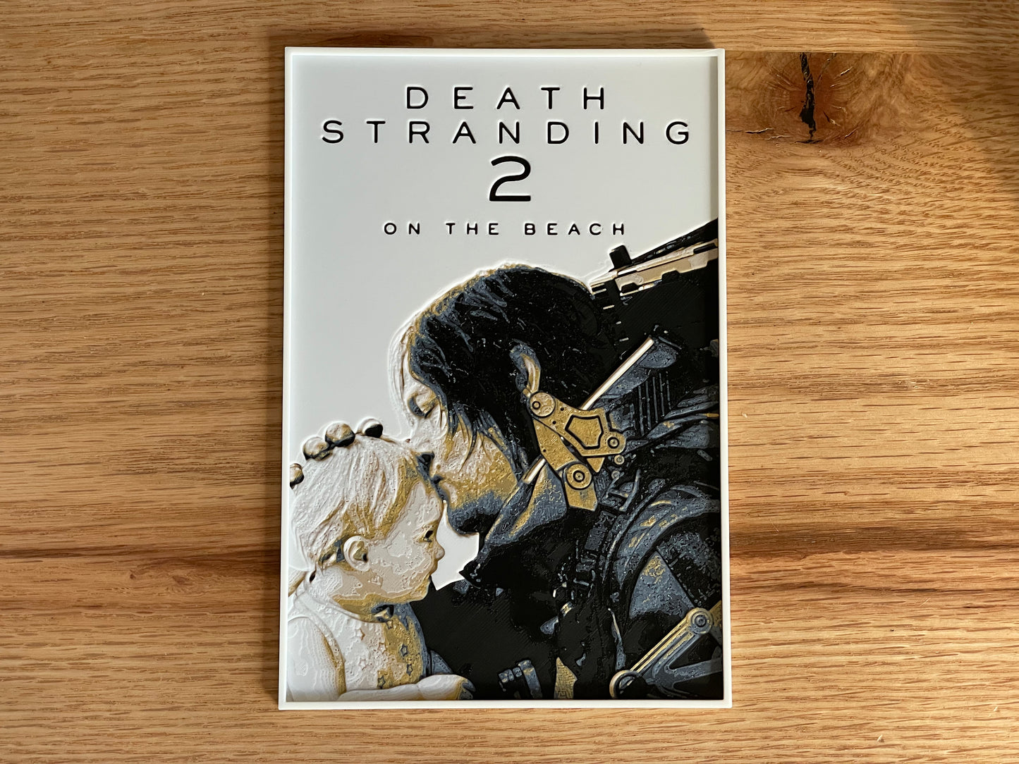 Poster for 'Death Stranding 2: On the Beach' on a wooden surface