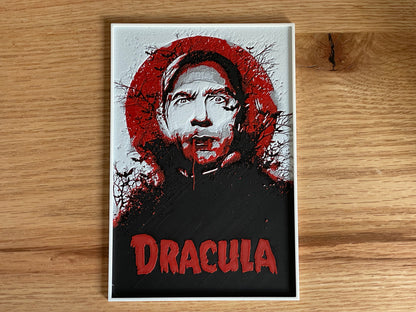 Poster of a character with a red circular design and 'Dracula' text on a wooden surface