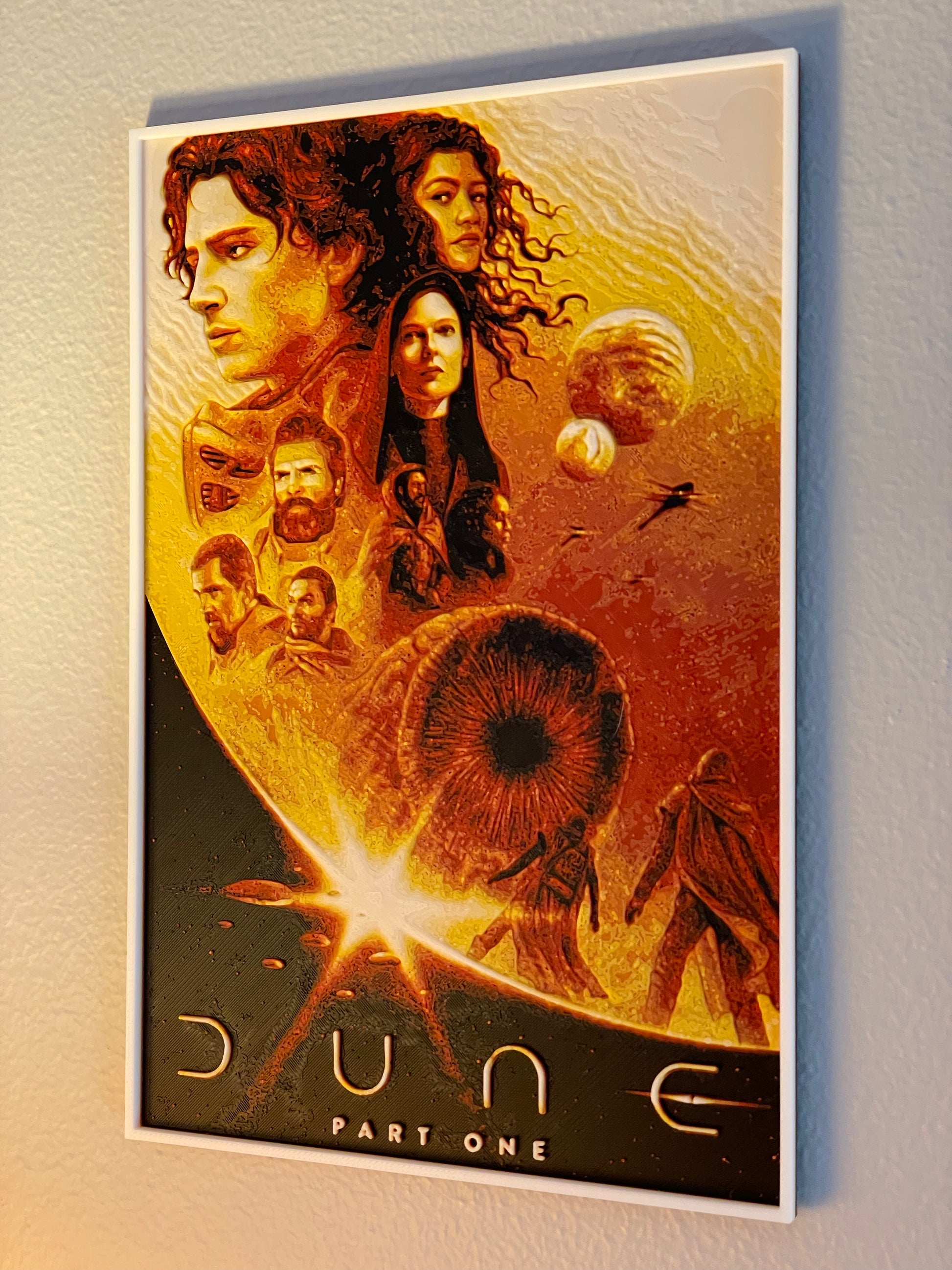 Movie poster for 'Dune Part One' with characters and desert landscape on a light gray background