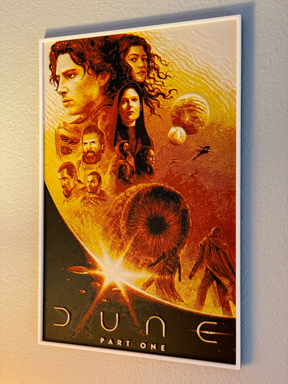 Movie poster for 'Dune Part One' with characters and desert landscape on a light gray background