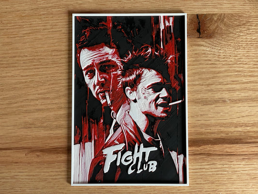 Poster of 'Fight Club' with two faces and the title on a wooden surface