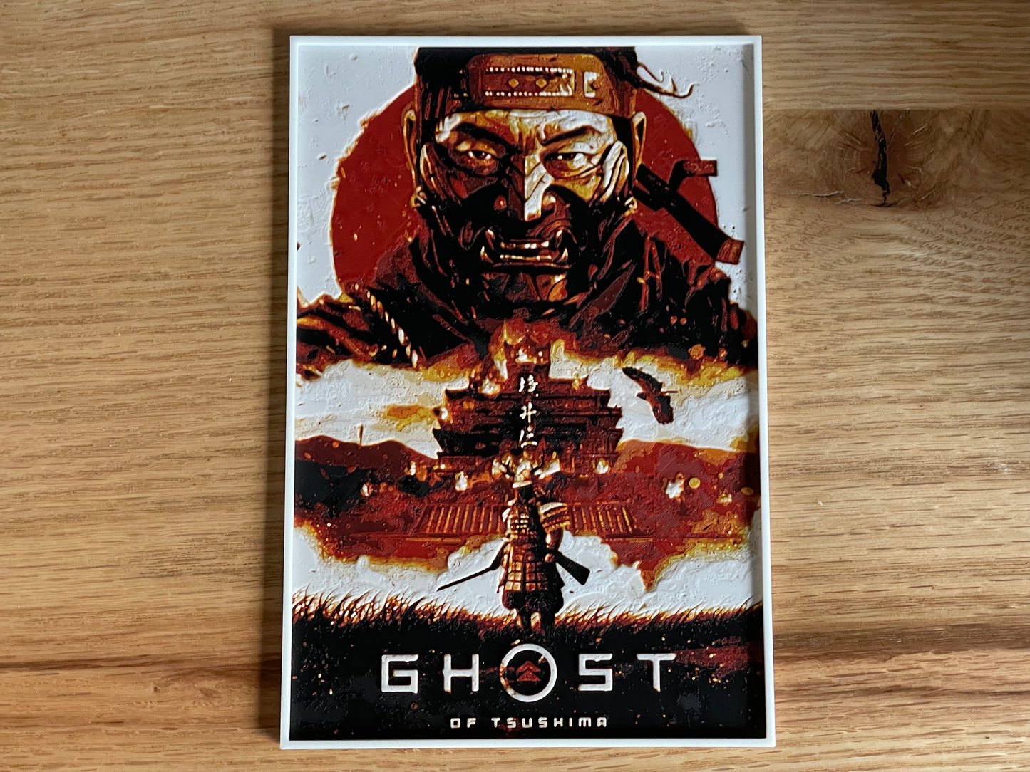 Poster of 'Ghost of Tsushima' game on a wooden surface