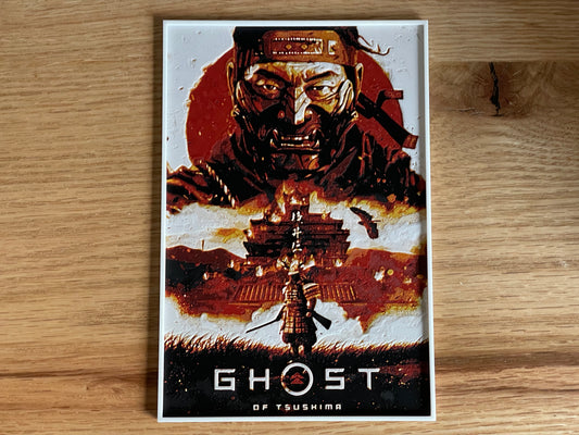 Poster of 'Ghost of Tsushima' game on a wooden surface