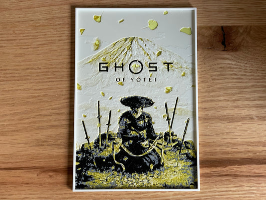 poster of 'Ghost of Yotei' with a samurai illustration on a wooden surface