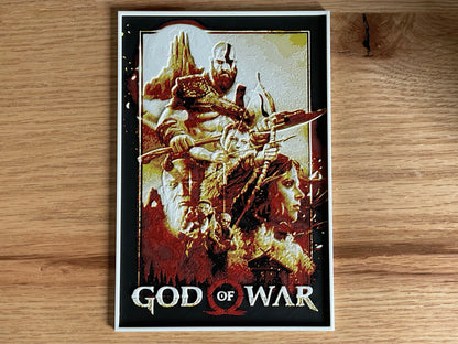 Poster of 'God of War' game cover art on a wooden surface