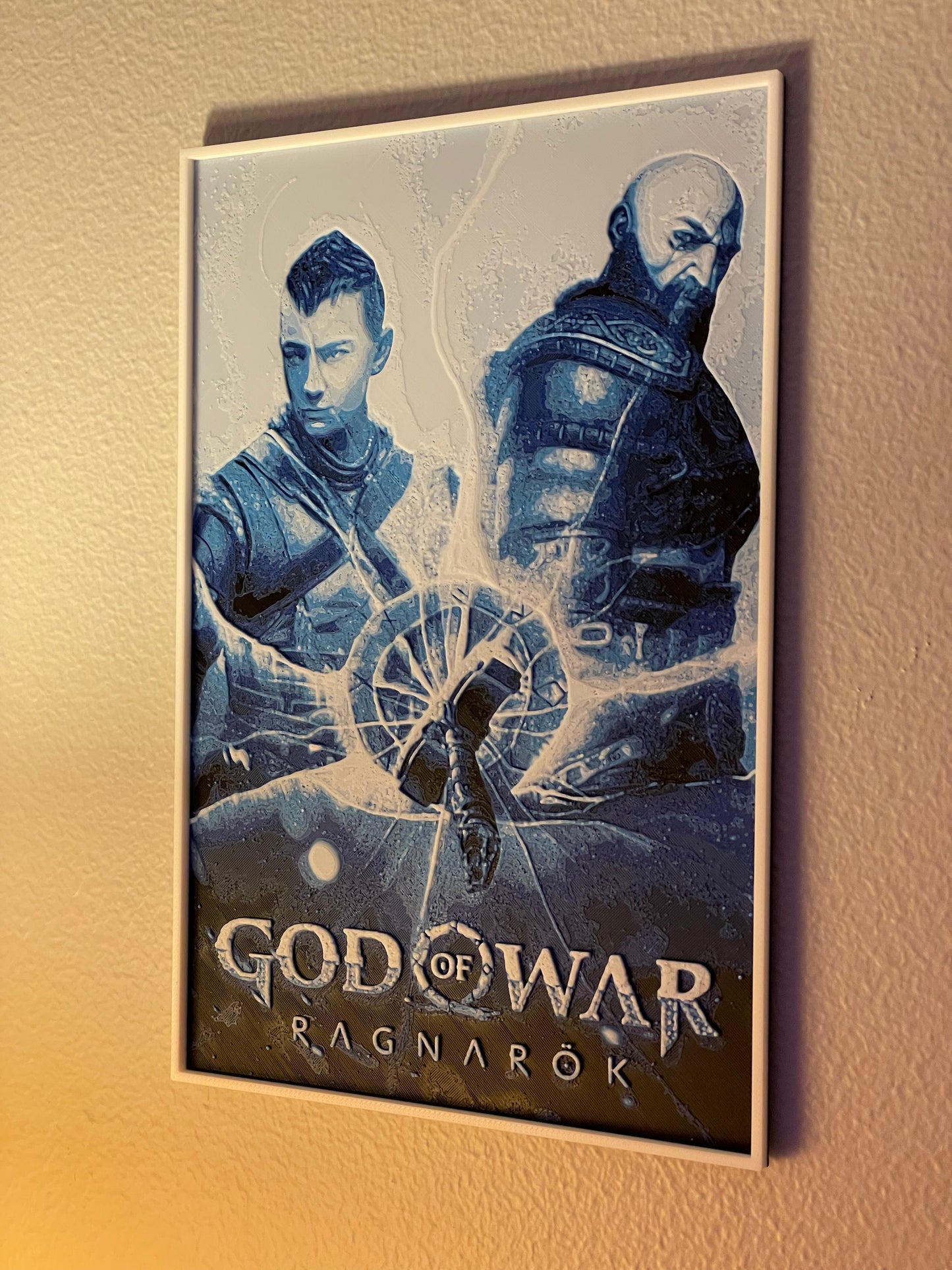 Framed 'God of War Ragnarok' poster with two characters on a beige wall.