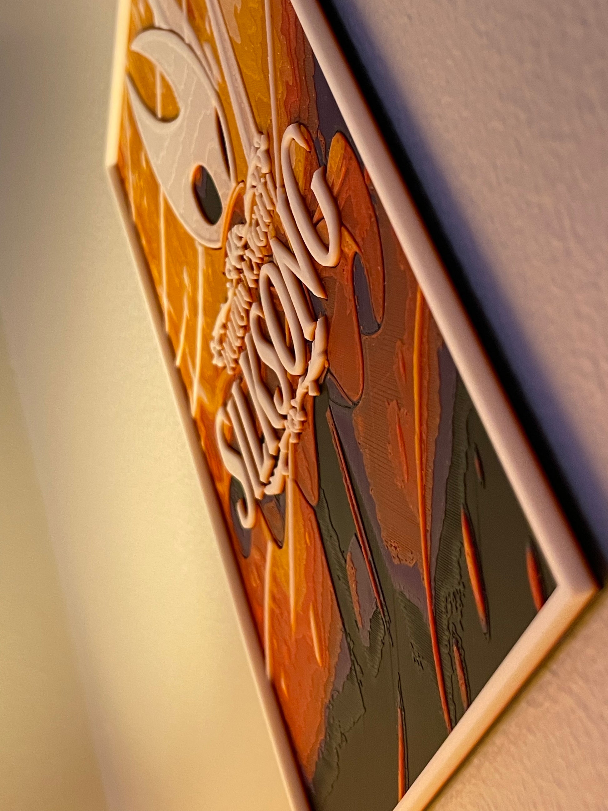 poster with 'silksong' engraved on it, placed on a textured surface.