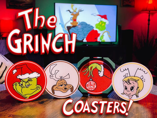 Set of Grinch-themed coasters with a TV screen displaying a Christmas scene in the background.