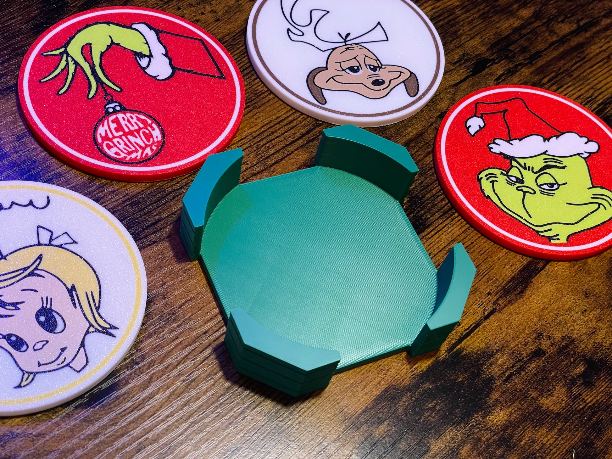 Set of coasters with cartoon characters on a wooden surface