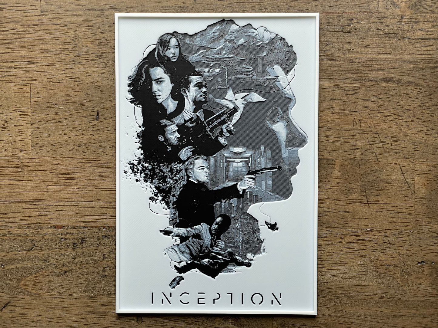Movie poster for 'Inception' on a wooden surface