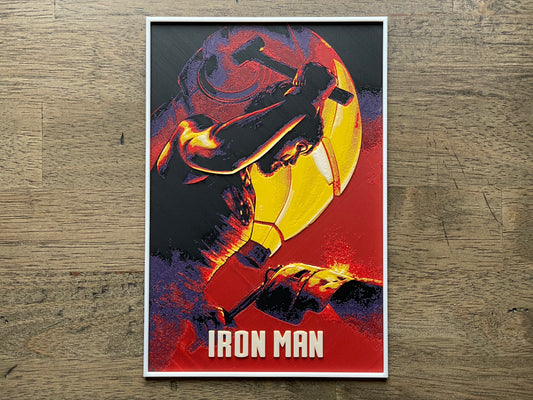 Poster of Iron Man in a dynamic pose with a colorful design on a wooden surface
