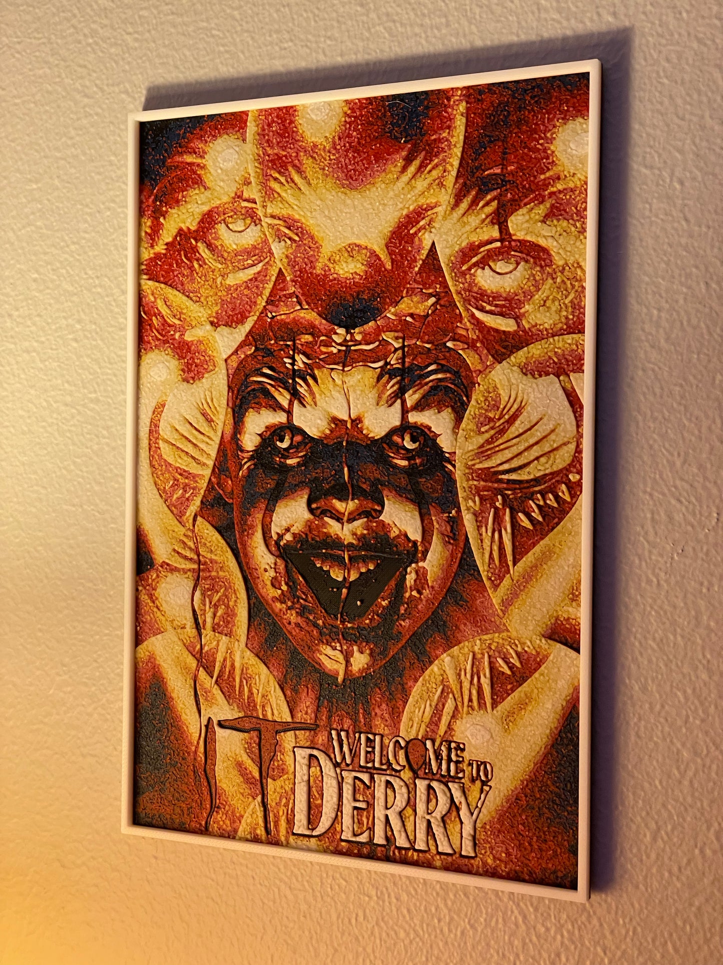 Poster with 'Welcome to Derry' text and a stylized pennywise face on a textured wall.
