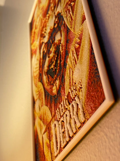 Wooden relief sculpture with engraved design on a plain background