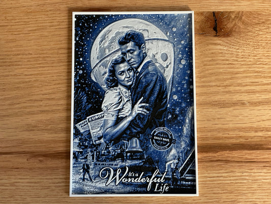 Poster of a couple embracing under a moonlit sky with 'It's a Wonderful Life' text on a wooden surface.