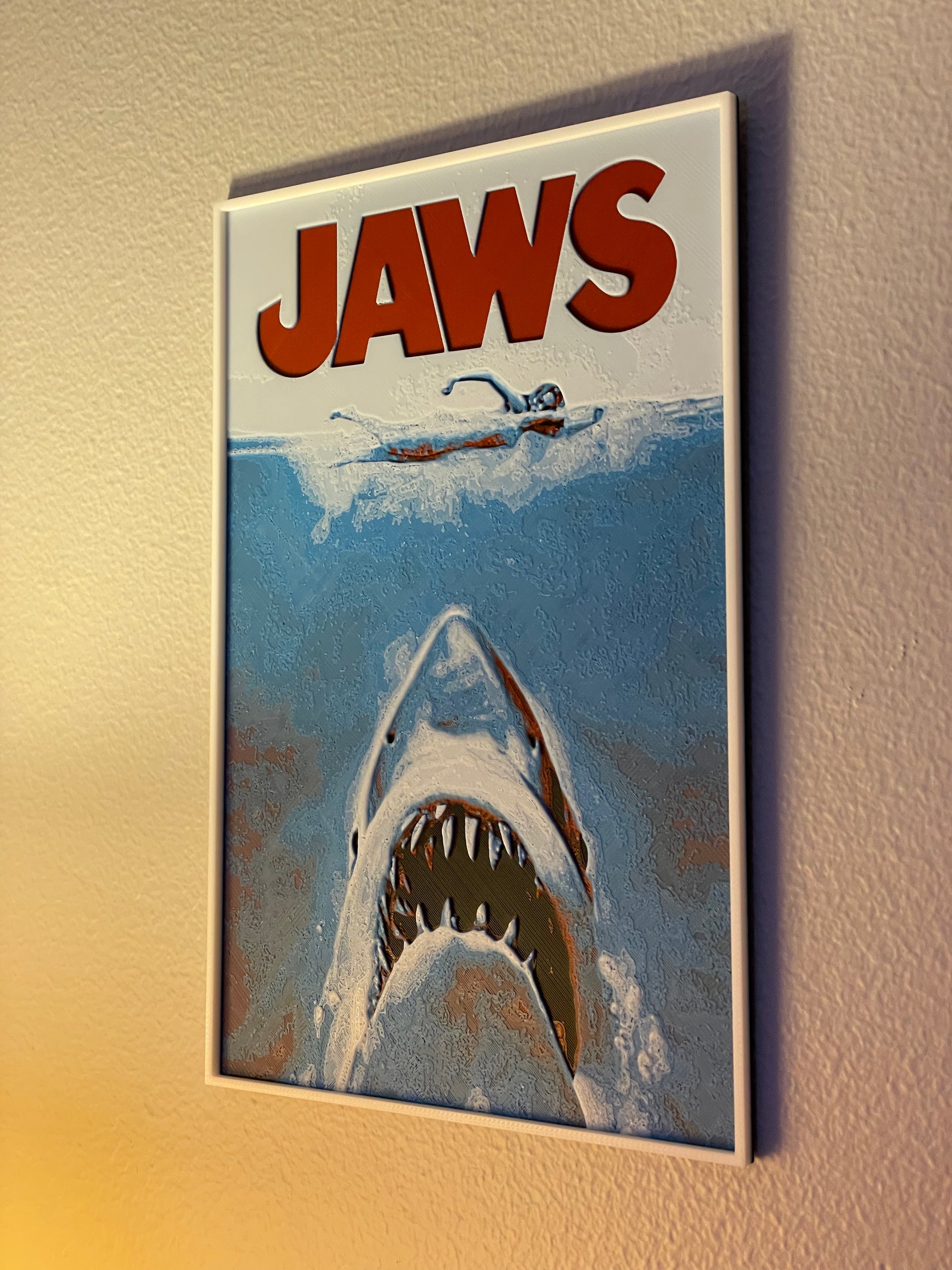 Framed 'Jaws' movie poster on a wall