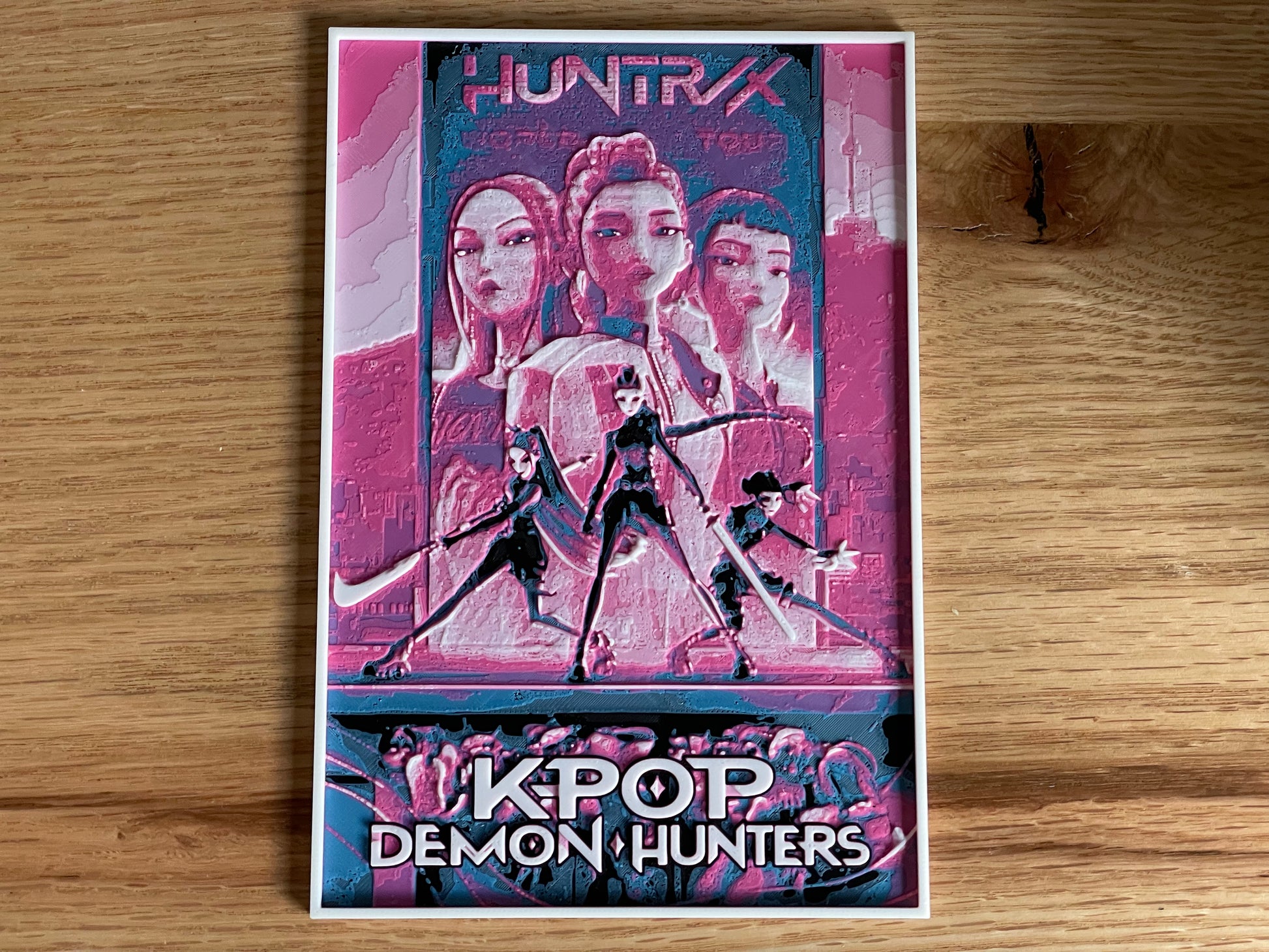 Poster of 'KPOP Demon Hunters' with stylized characters on a wooden surface