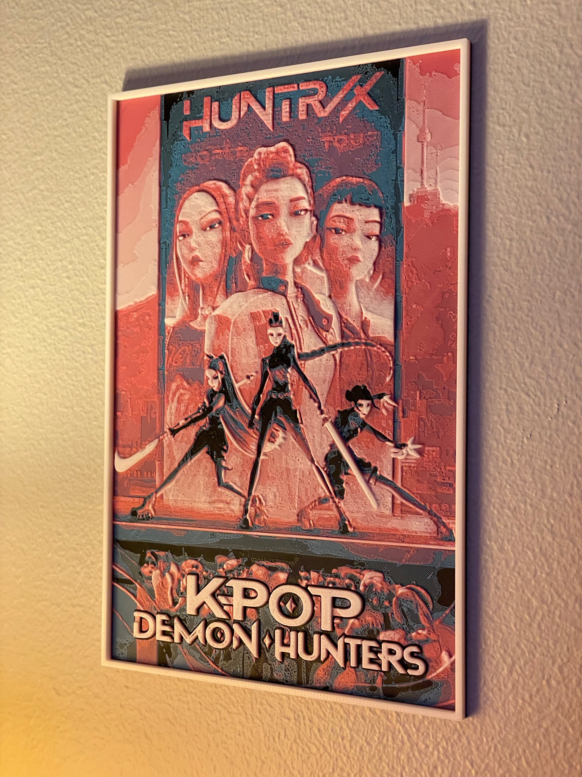 Framed poster of 'Huntrix' featuring four characters with a cityscape background.