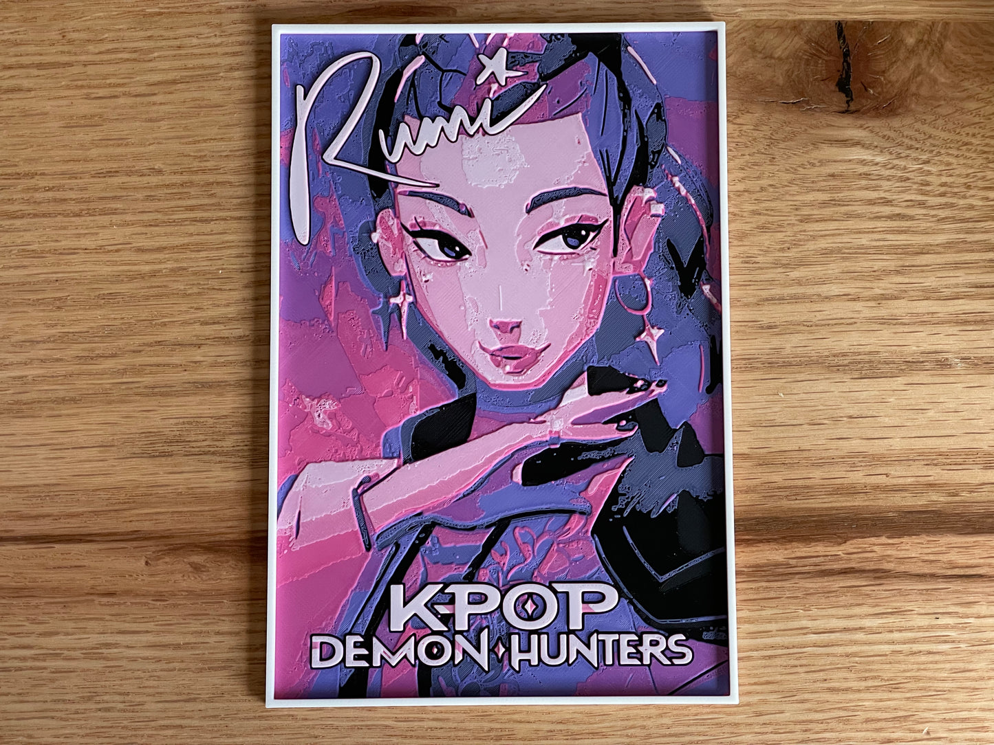 Poster of a character from 'KPOP Demon Hunters' with stylized text on a wooden surface