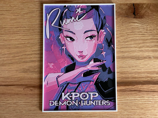 Poster of a character from 'KPOP Demon Hunters' with stylized text on a wooden surface