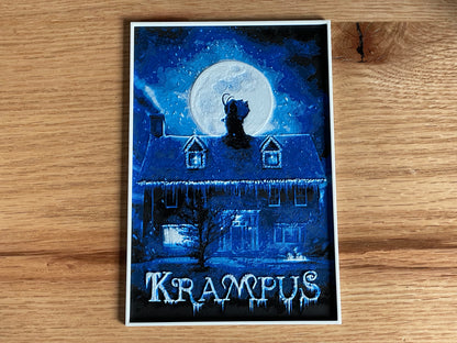 Poster of Krampus with a house and moon on a wooden surface