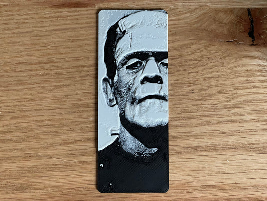 Frankenstein bookmark with a black and white illustration of a famous character on a wooden surface