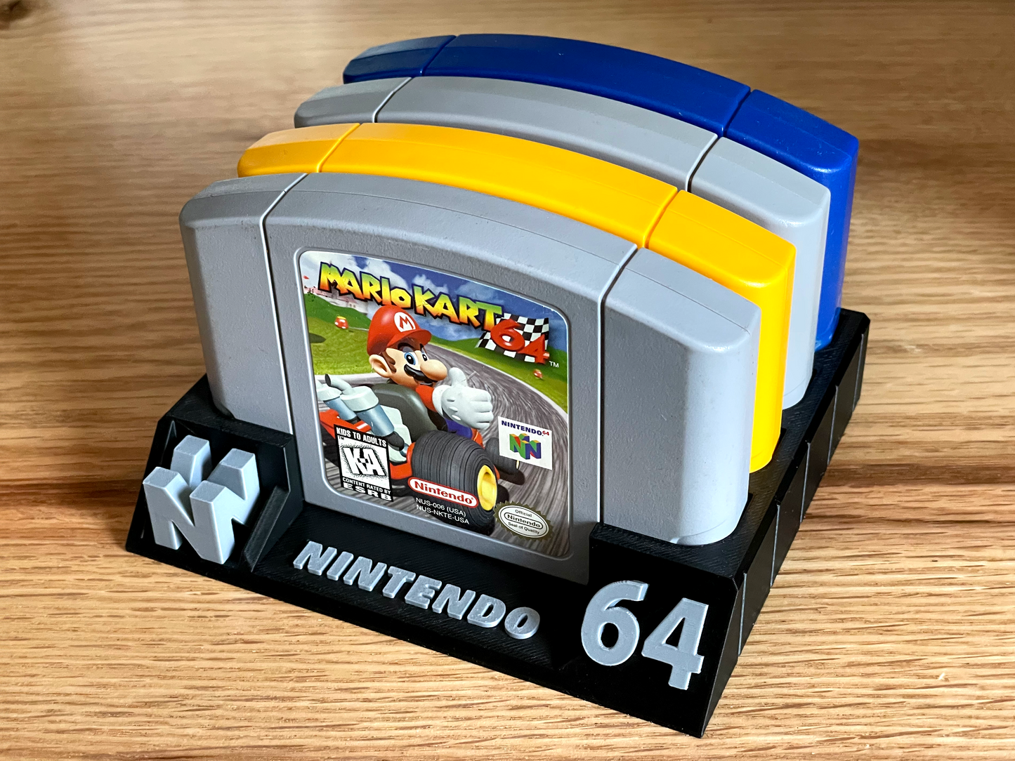 Nintendo 64 game cartridge display with 'Mario Kart' on a wooden surface