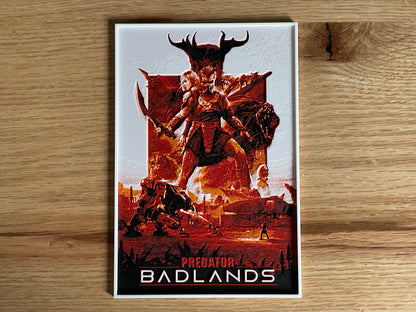 Poster of 'Predator Badlands' with a creature and text on a wooden surface