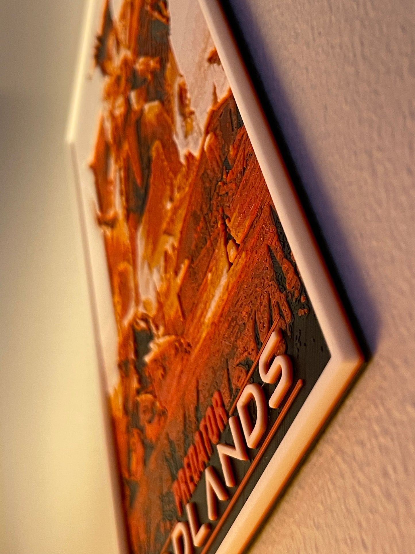 Close-up of a decorative plaque with text on a textured surface.
