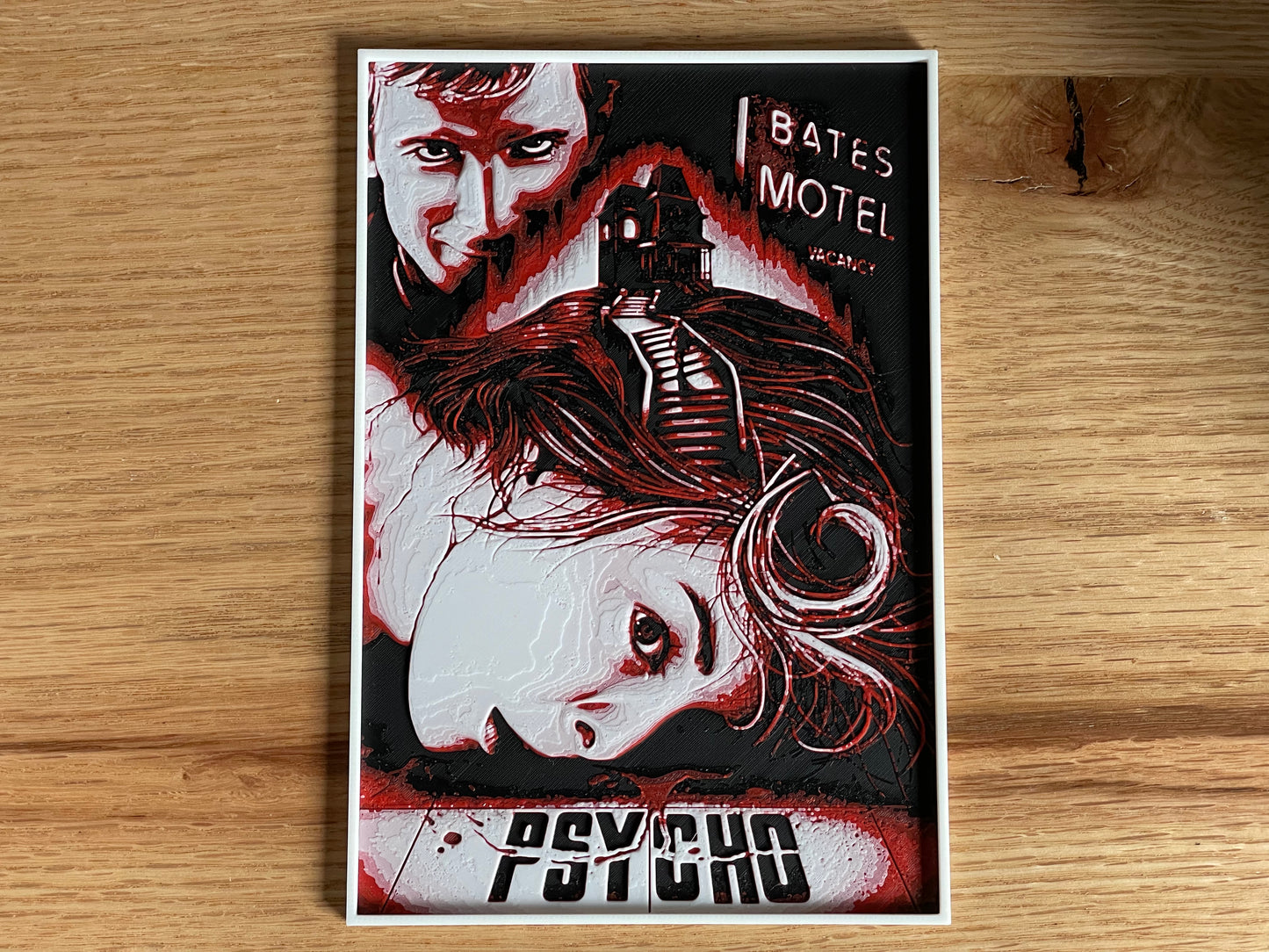 Poster of 'Psycho' with a stylized illustration on a wooden surface