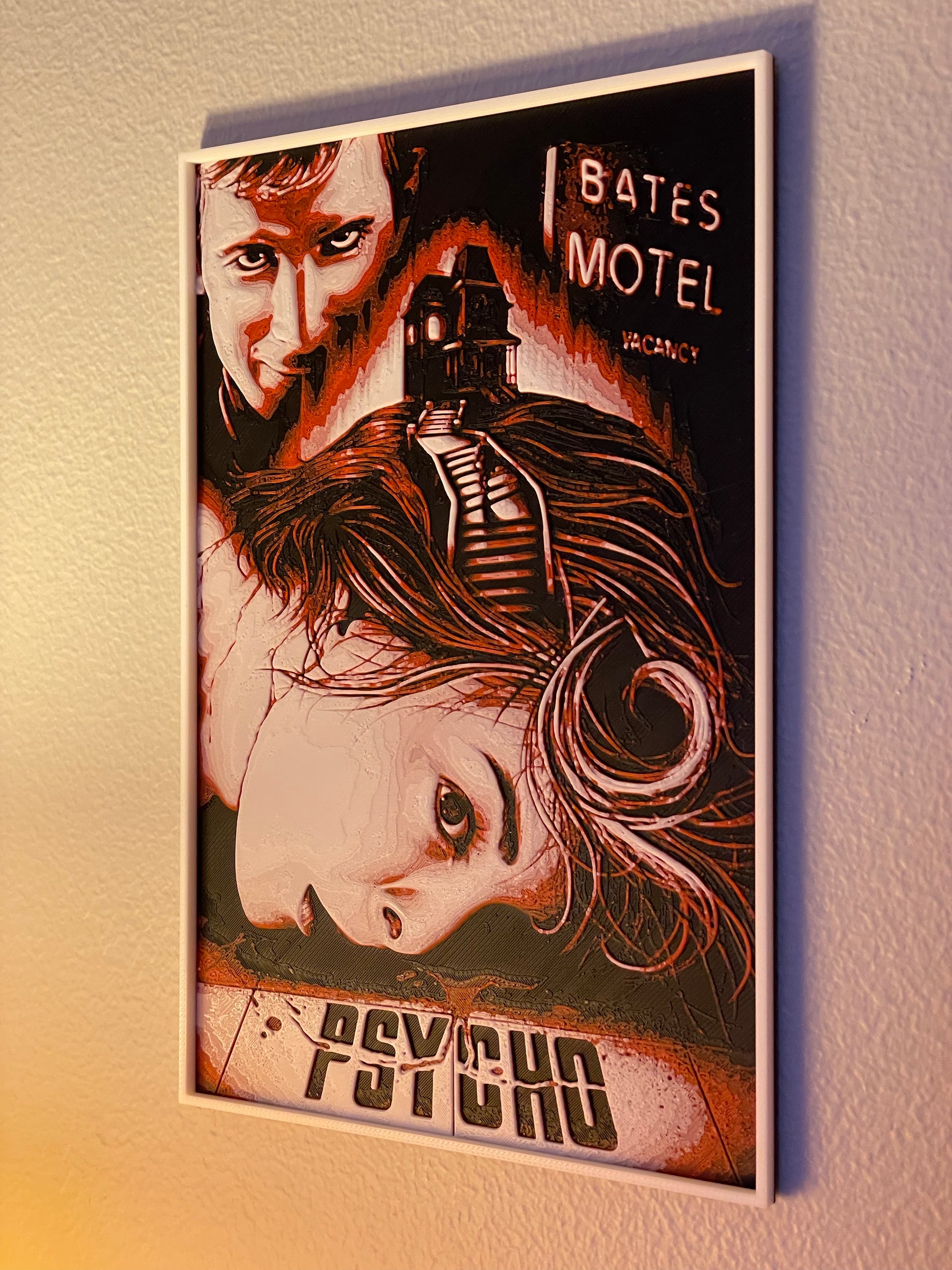 Framed poster of 'Psycho' with a woman's face and text on a wall.