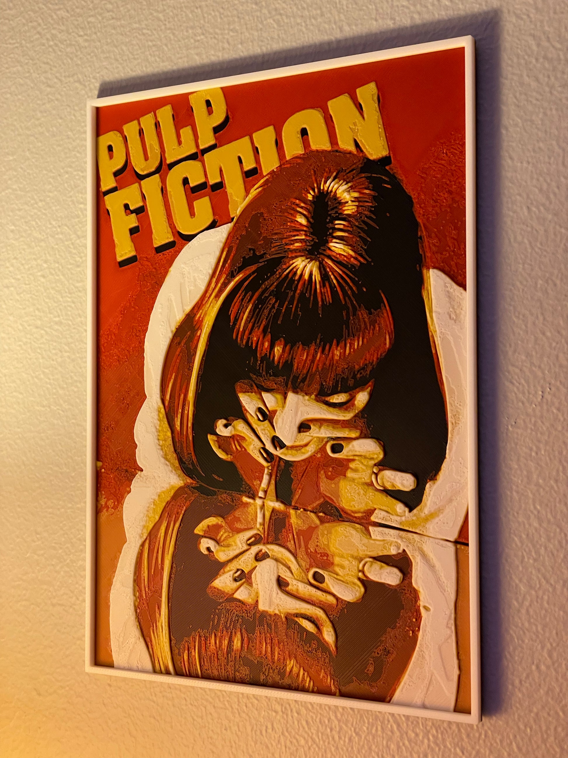 Framed poster of a stylized illustration with text 'Pulp Fiction' on a plain wall.